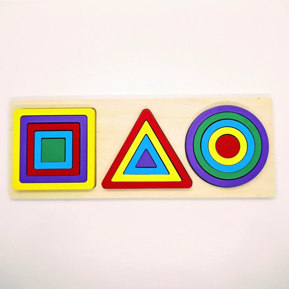 Triplet Geometric Shapes Puzzle with colorful wooden circles, triangles, and squares on a wooden board