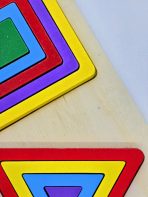 Triplet Geometric Shapes Puzzle with colorful wooden circles, triangles, and squares on a wooden board