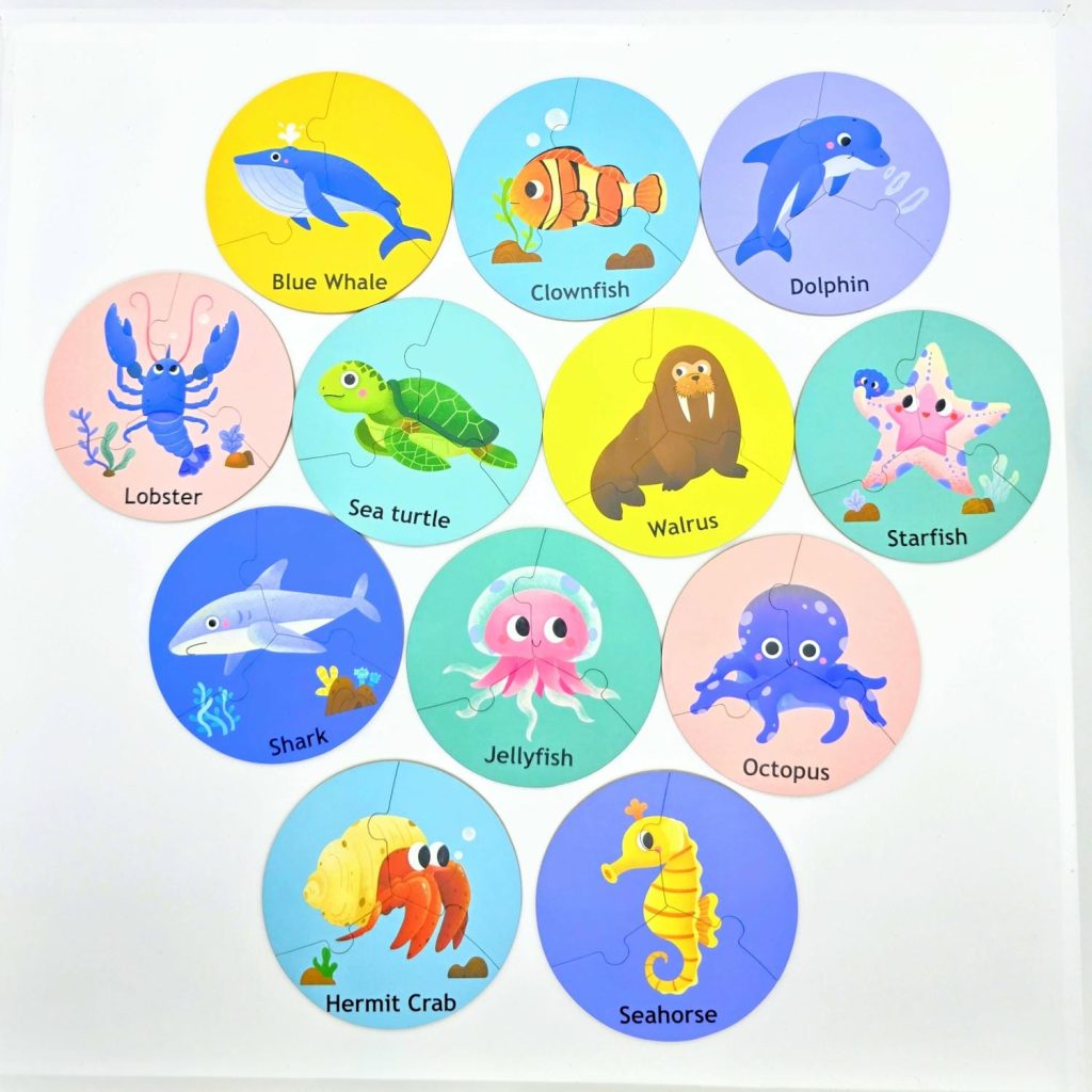 Ocean Explorer Circular Puzzle featuring 12 sea animals like dolphin, shark, and octopus in 3-piece wooden blocks