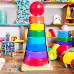 Wooden Rainbow Tower Stack with colorful rings and a wooden base for toddler skill development